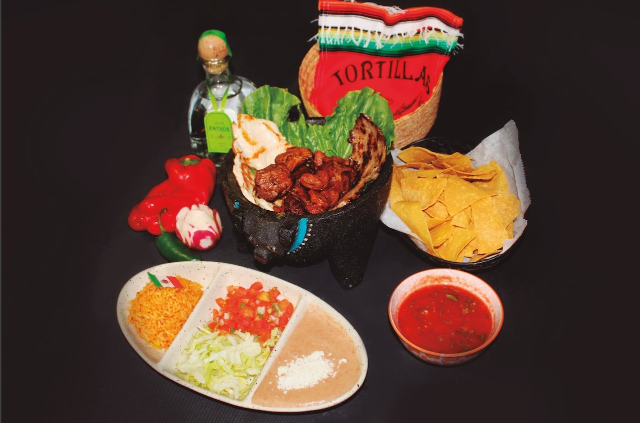 Festive dish presentation with molcajete and tortillas